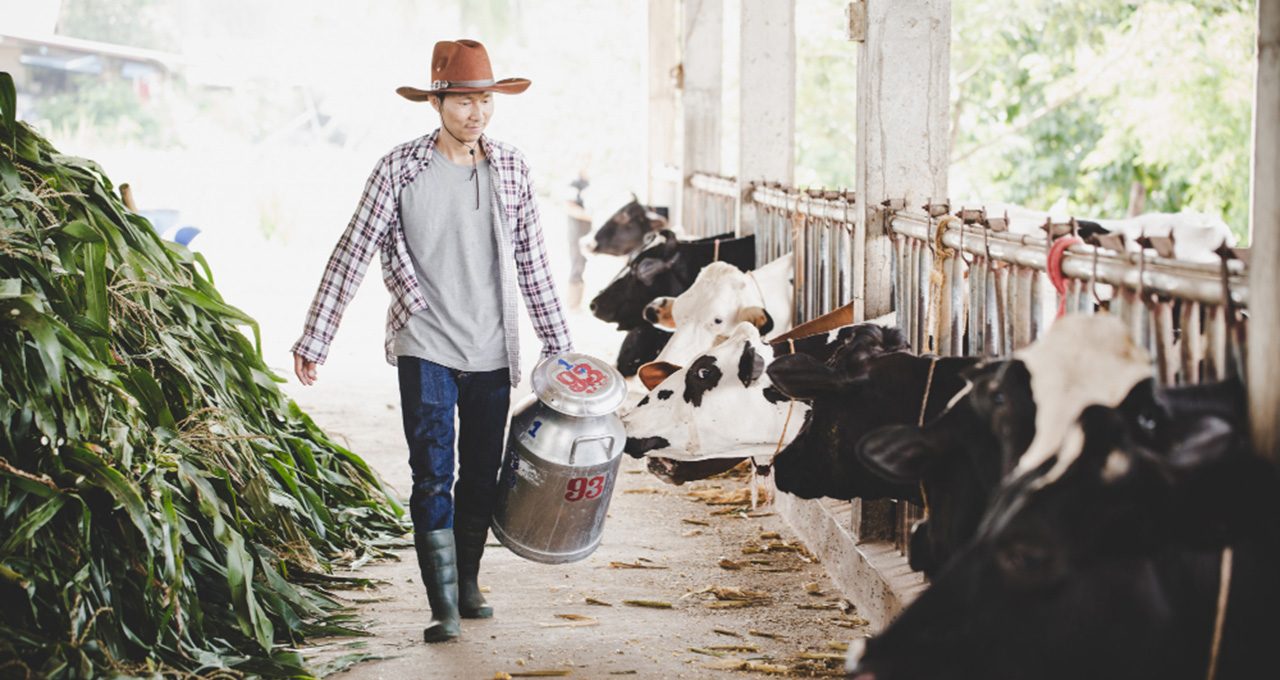 portrait-handsome-milkman-walking-with-milk-container-outdoors-rural-scene-featured